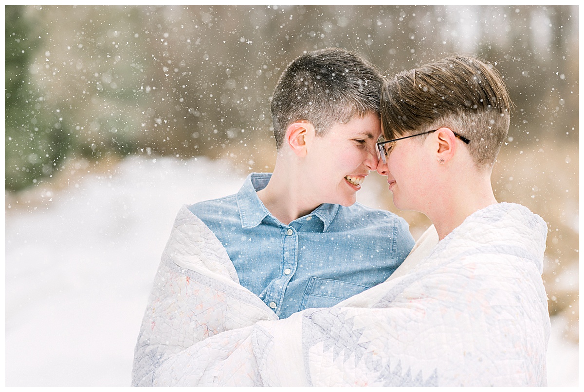 sweet couple smiling together in the snow