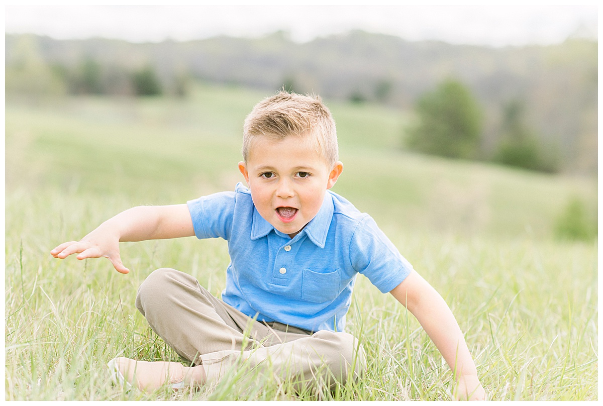child sitting in a field grinning Top Recommended Pediatricians in the Triad